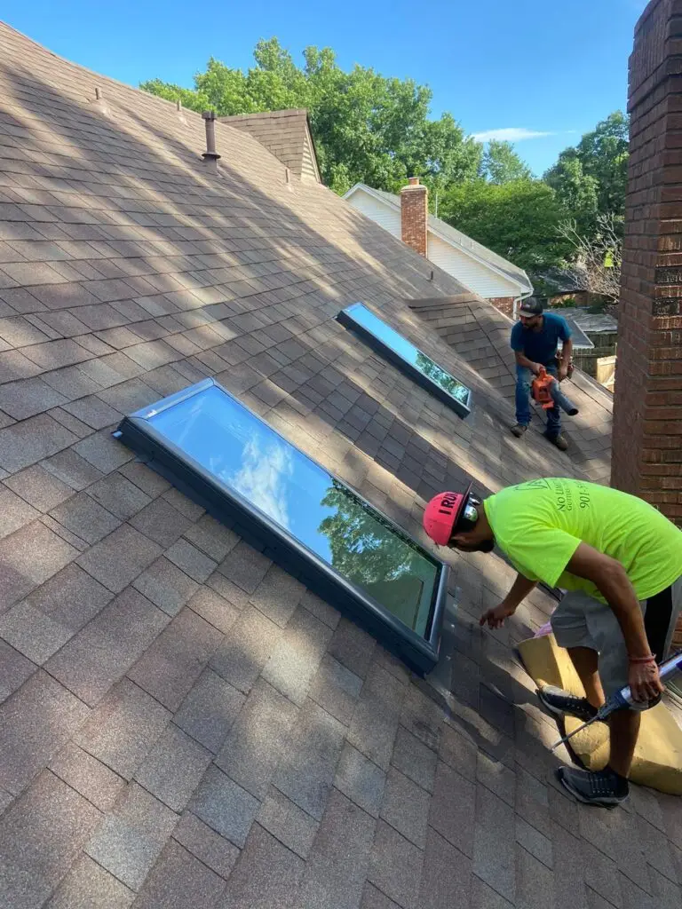 two guys finishing up installing skylights